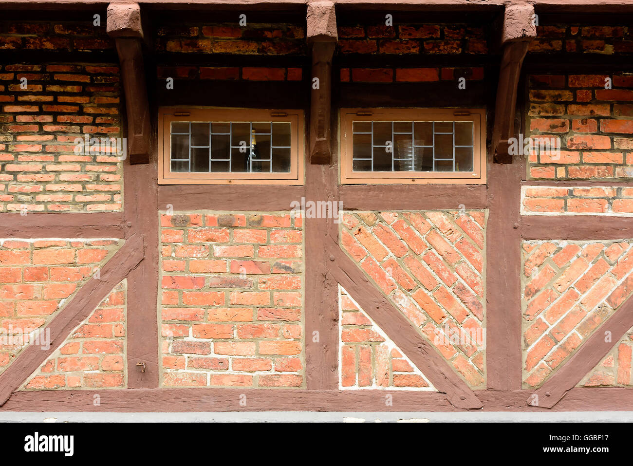 Small windows under an overhang on an old vintage house. Architectural detail and copy space. Stock Photo