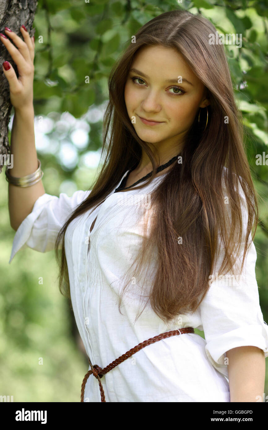 Portrait of a young beautiful girl standing near birch Stock Photo - Alamy
