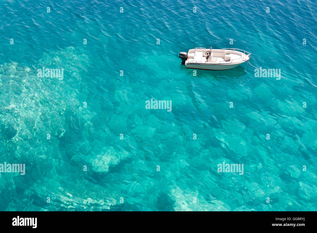 Speedboat anchored in turquoise water bay, high angle view Stock Photo