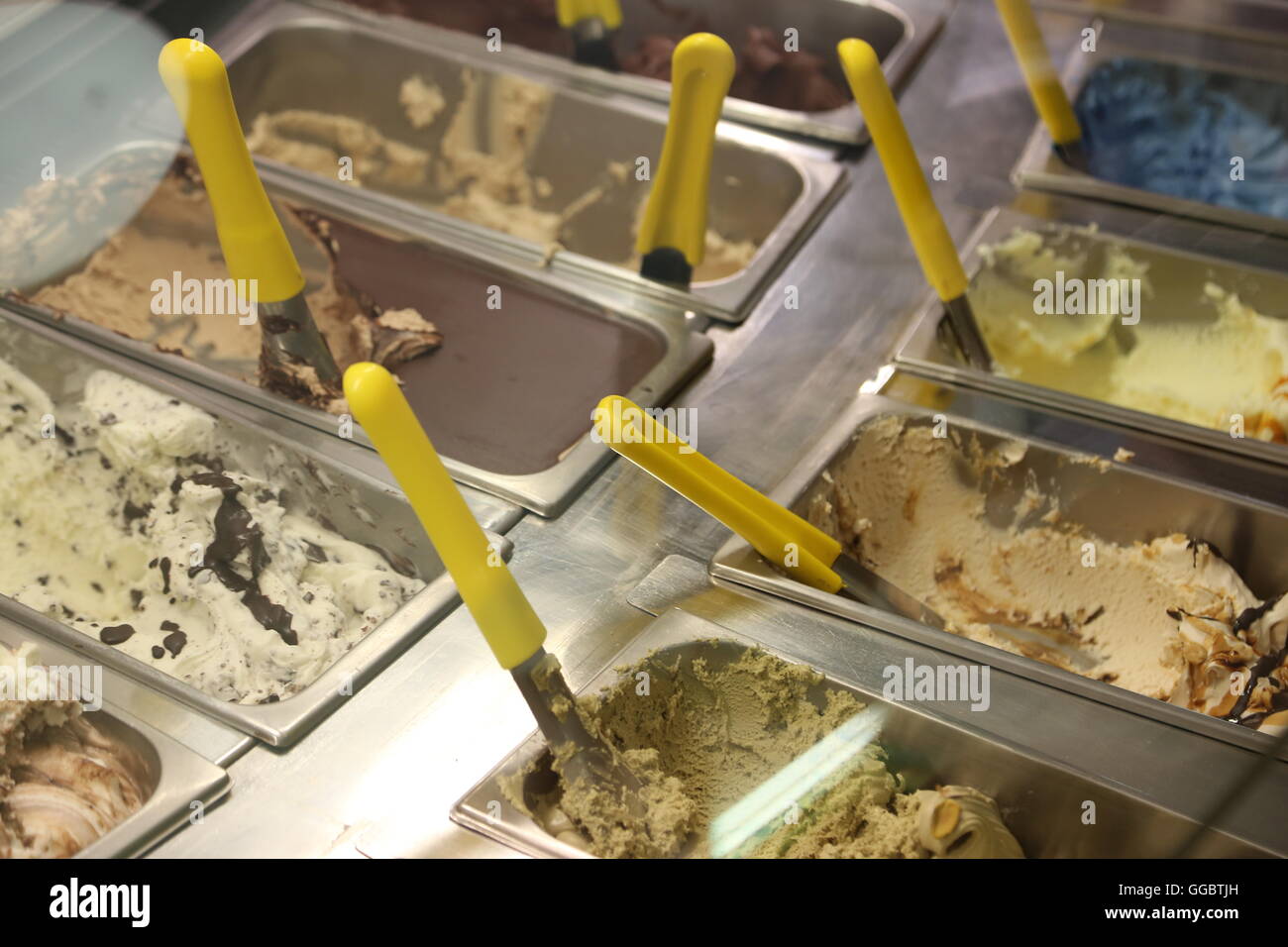 stainless steel tray with lots of fruit and cream ice-cream in the ice cream maker Stock Photo