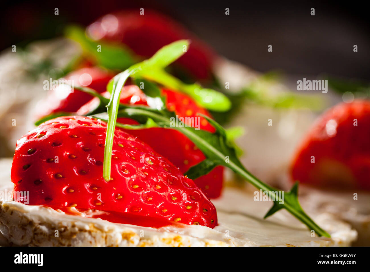 Multigrain rice cakes with strawberries fruit , soft mascarpone cheese