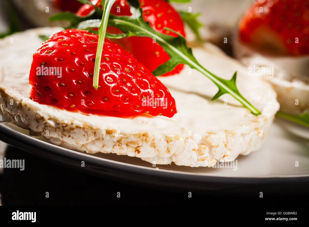 Multigrain rice cakes with strawberries fruit , soft mascarpone cheese