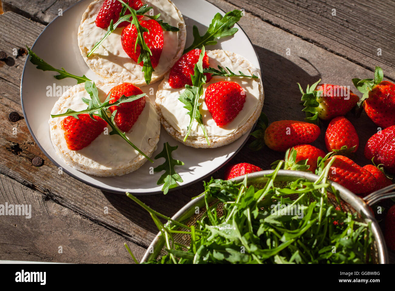 Multigrain rice cakes with strawberries fruit , soft mascarpone cheese