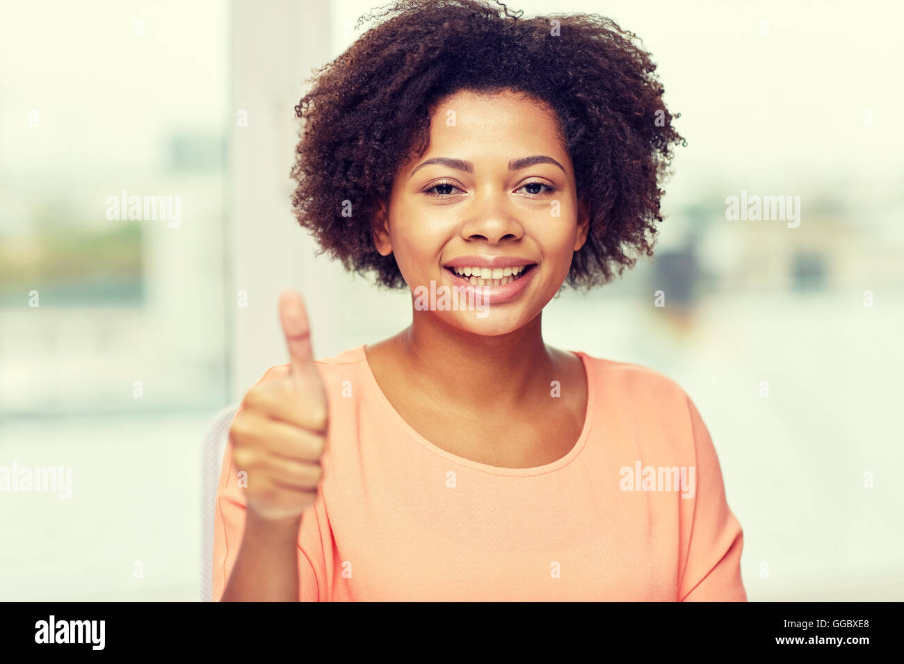 happy african young woman showing thumbs up Stock Photo - Alamy