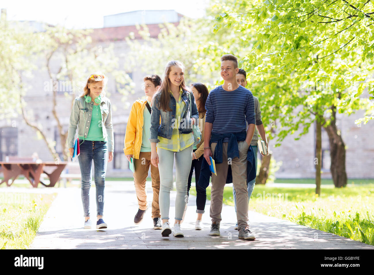 group of happy teenage students walking outdoors Stock Photo - Alamy