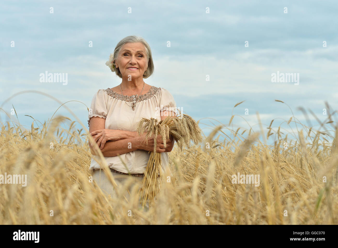 senior woman in summer field Stock Photo - Alamy
