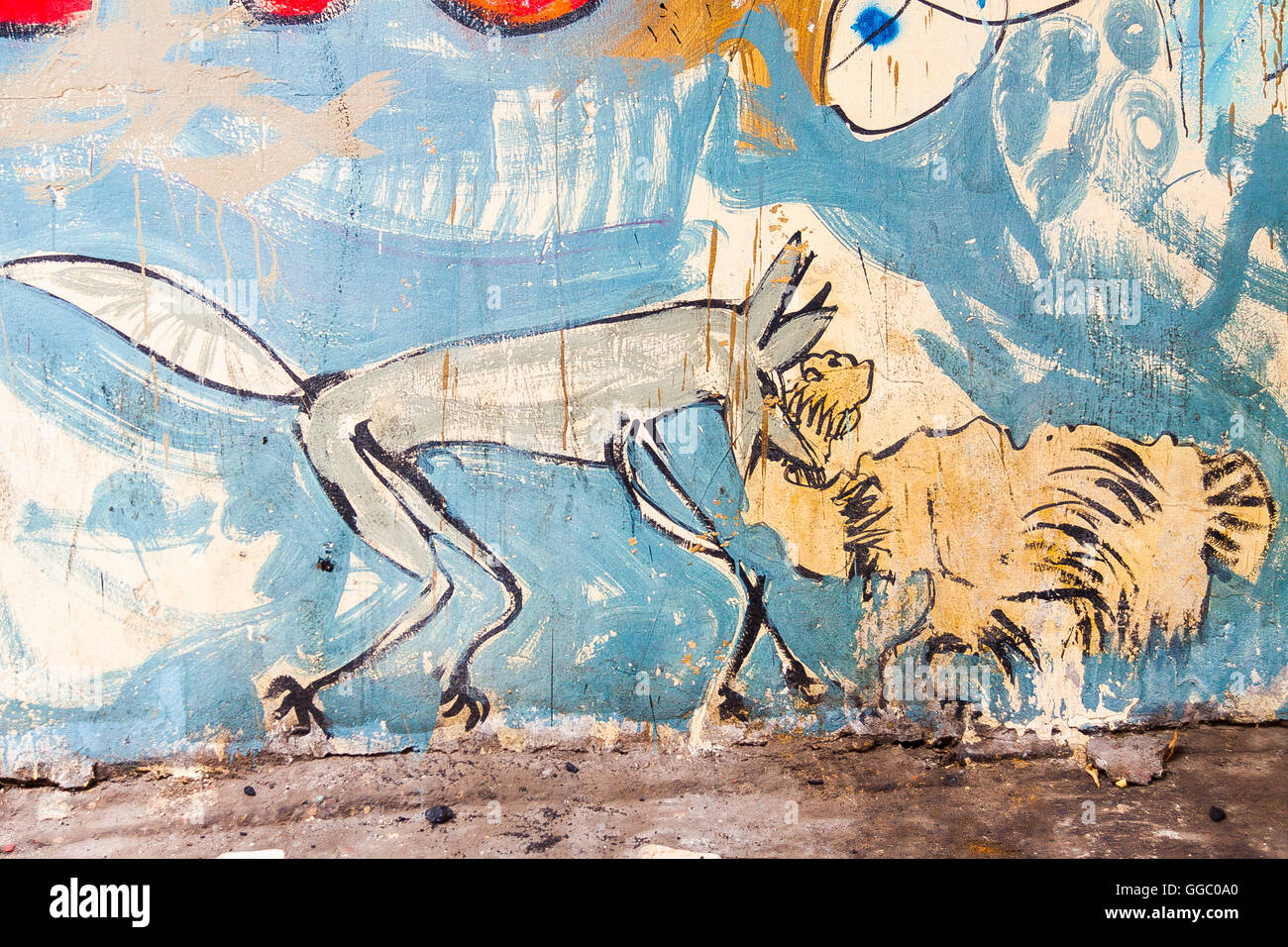 Egypt, Cairo, graffiti of the Egyptian revolution on Mohamed Mahmoud Street. A fox (or a wolf) eats a hen. Stock Photo