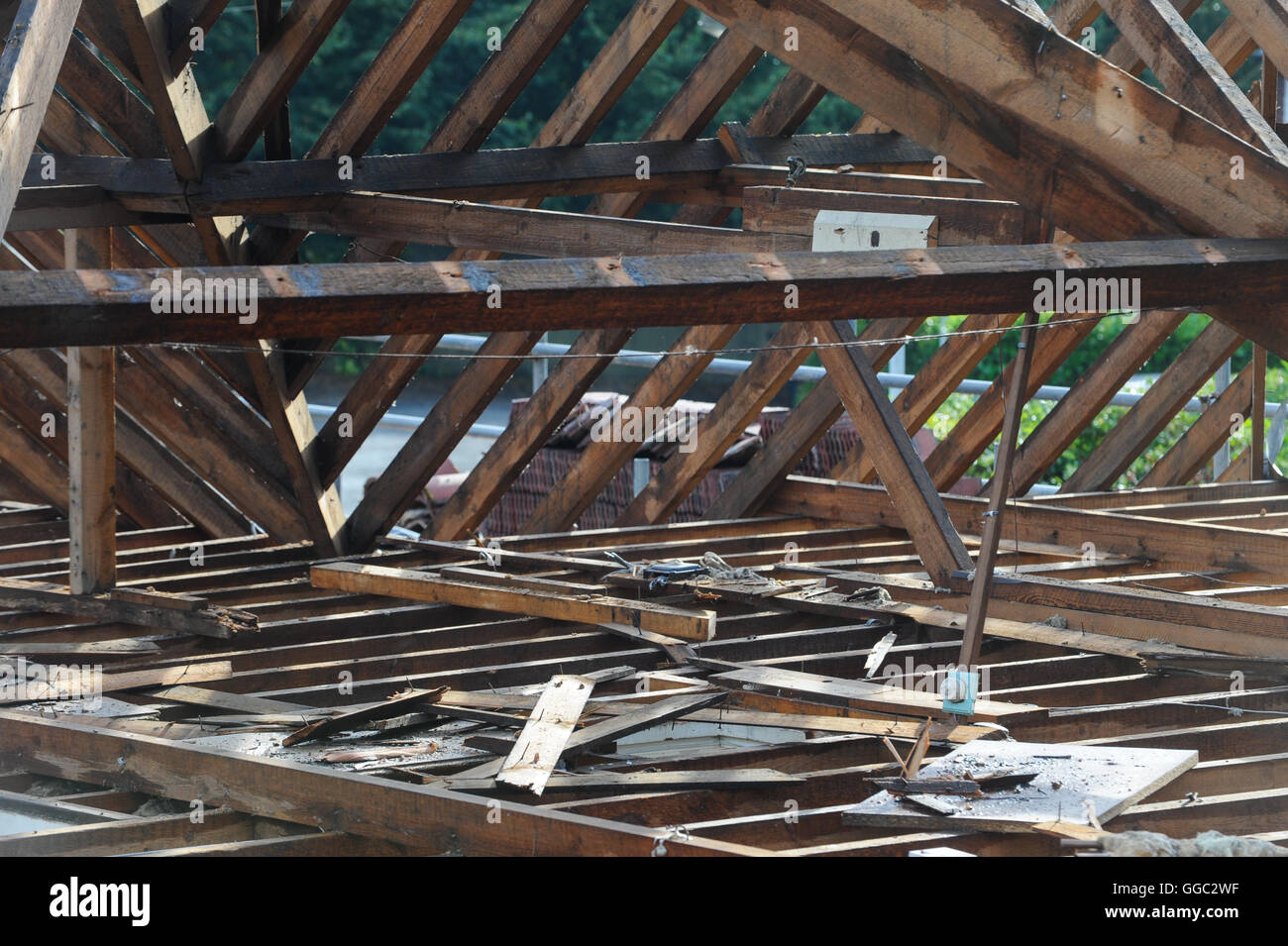 Break in the wet August weather allows for the roofing trades to work on rebuilding roof beams. Stock Photo