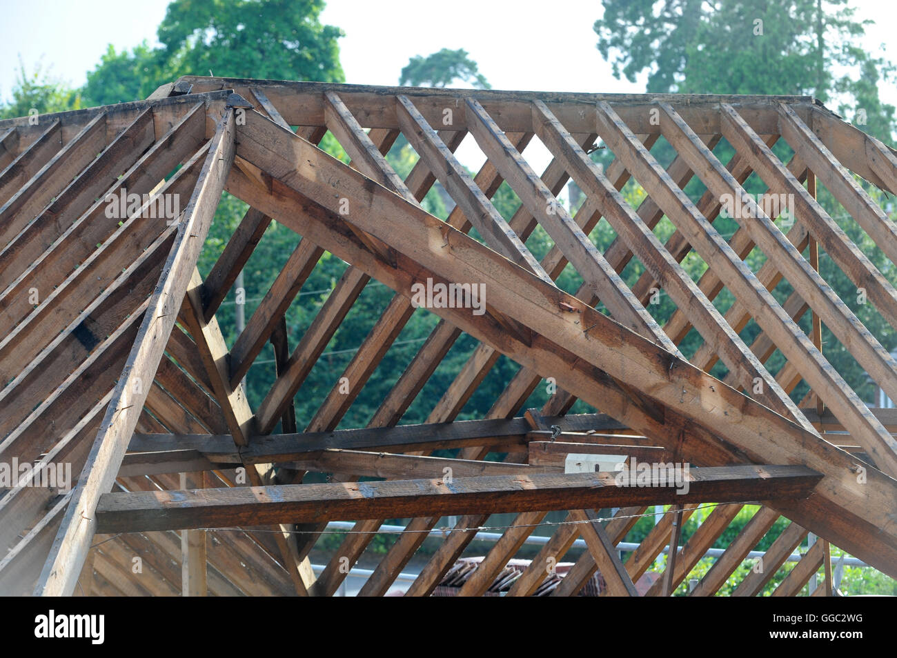Break in the wet August weather allows for the roofing trades to work on rebuilding roof beams. Stock Photo