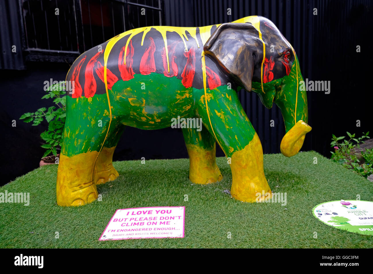 Model elephant in vivid green yellowq and red colours used for a promotional advertisement in Clonakilty co. Cork Ireland Stock Photo
