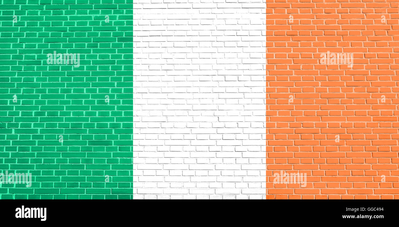 Flag of Ireland on brick wall texture background. Irish national flag. Stock Photo