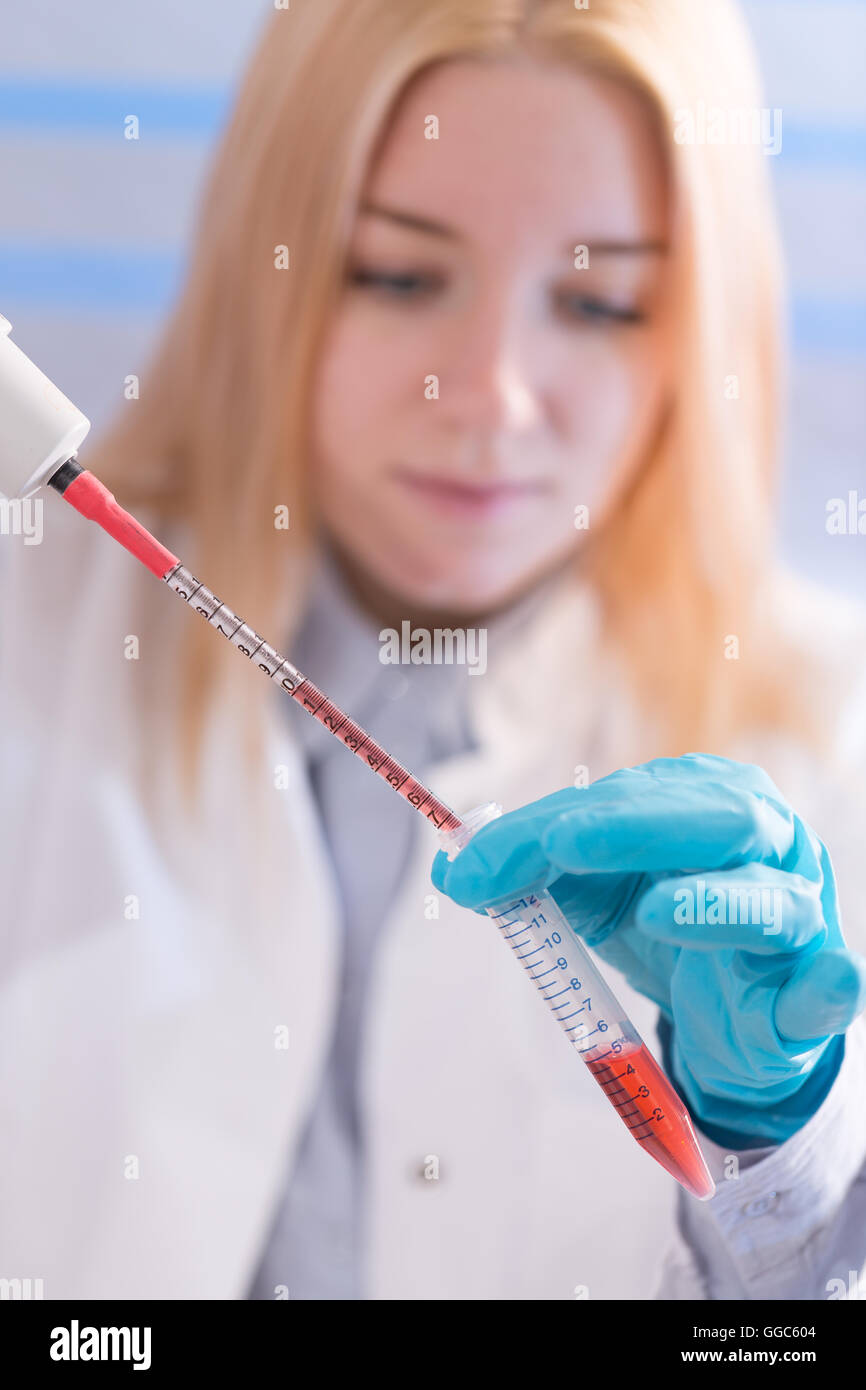 woman assistant in laboratory with multi pipette in the clinic, the research of cancer stem cells Stock Photo