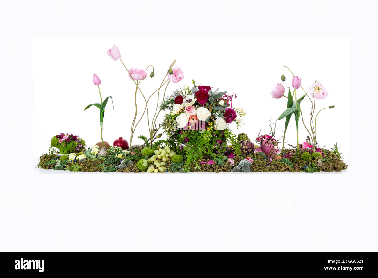 Large floral table display of Australian flowers, moss, ferns, nuts and fruit Stock Photo