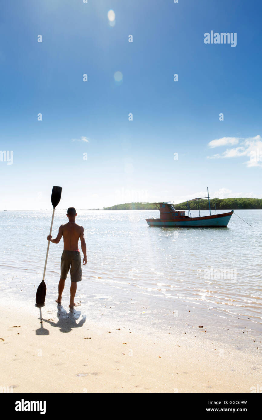 geography / travel, Brazil, Bahia, Santo Andre, a man with a kayak paddle near Porto Seguro, silhouetted against the setting sun (MR), Additional-Rights-Clearance-Info-Not-Available Stock Photo
