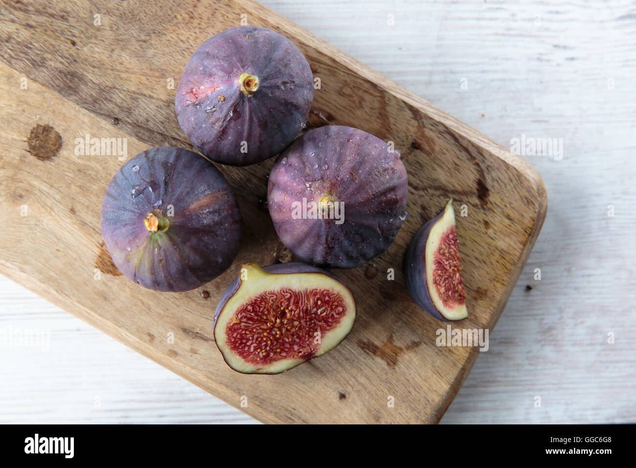 Delicious fresh dark figs on a chopping board Stock Photo Alamy