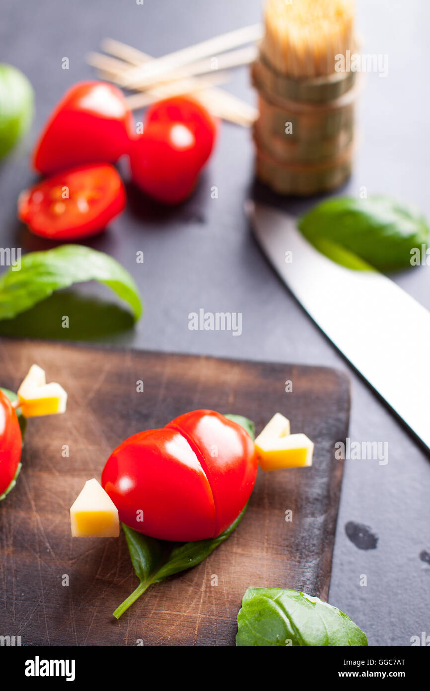 Marinated fillet with tomato heart shaped.  Appetizer for a party. Valentine's Day treat for your loved one. Stock Photo