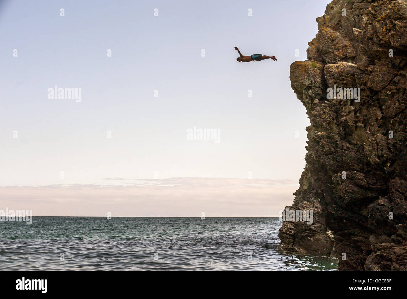 A cliffdiver diving into the sea on the south coast of England Stock