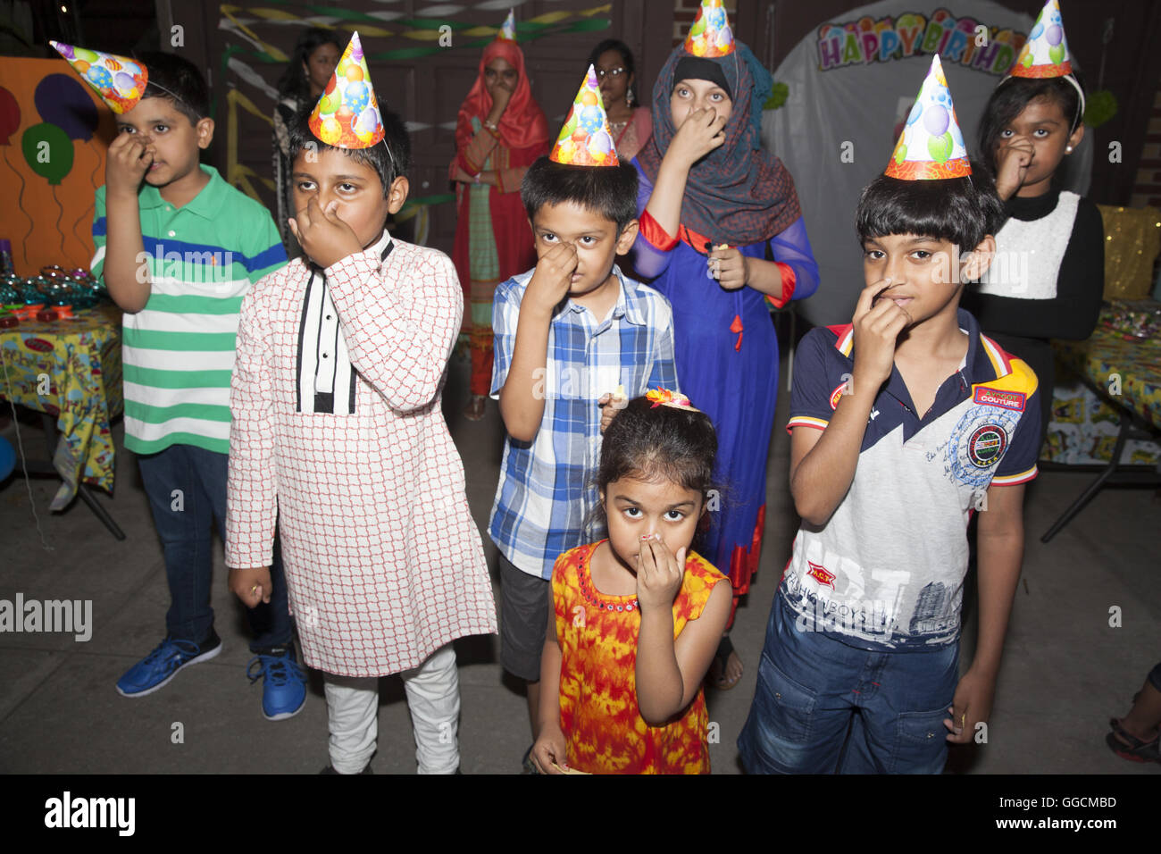 Bangladeshi family and friends celebrate the birthday of their 3 year