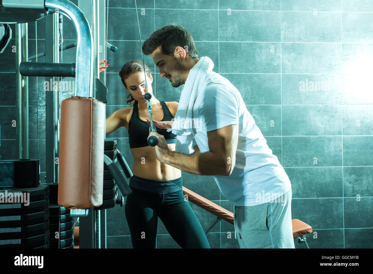 A young couple training together in the Gym Stock Photo - Alamy