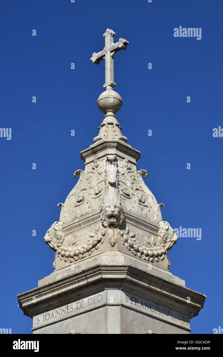 Holy cross at the top of monument erected in Tiber Island (Rome) and made by sculptor Jacometti in 1869 Stock Photo