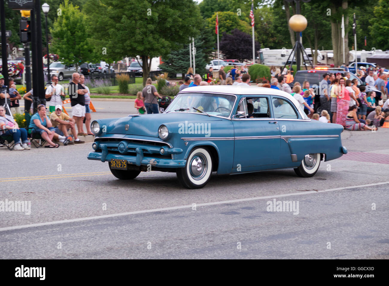 1954 Ford, 2-door, sedan participates in the 2016 Annual Cruz In parade in downtown Montague, Michigan. Stock Photo