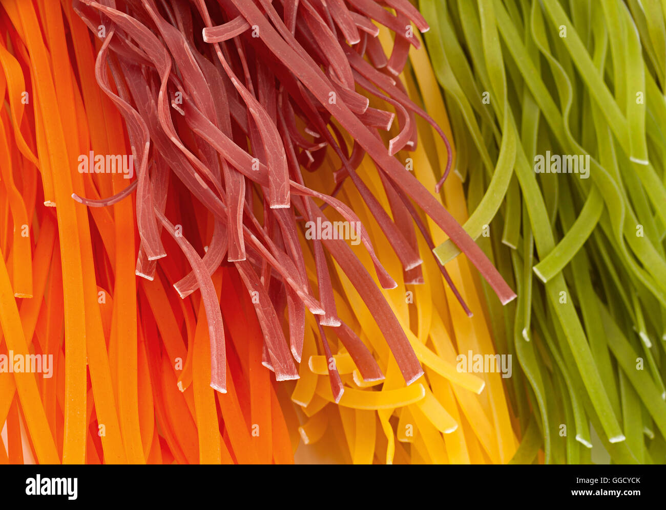 Wheat multicolored noodles closeup background Stock Photo