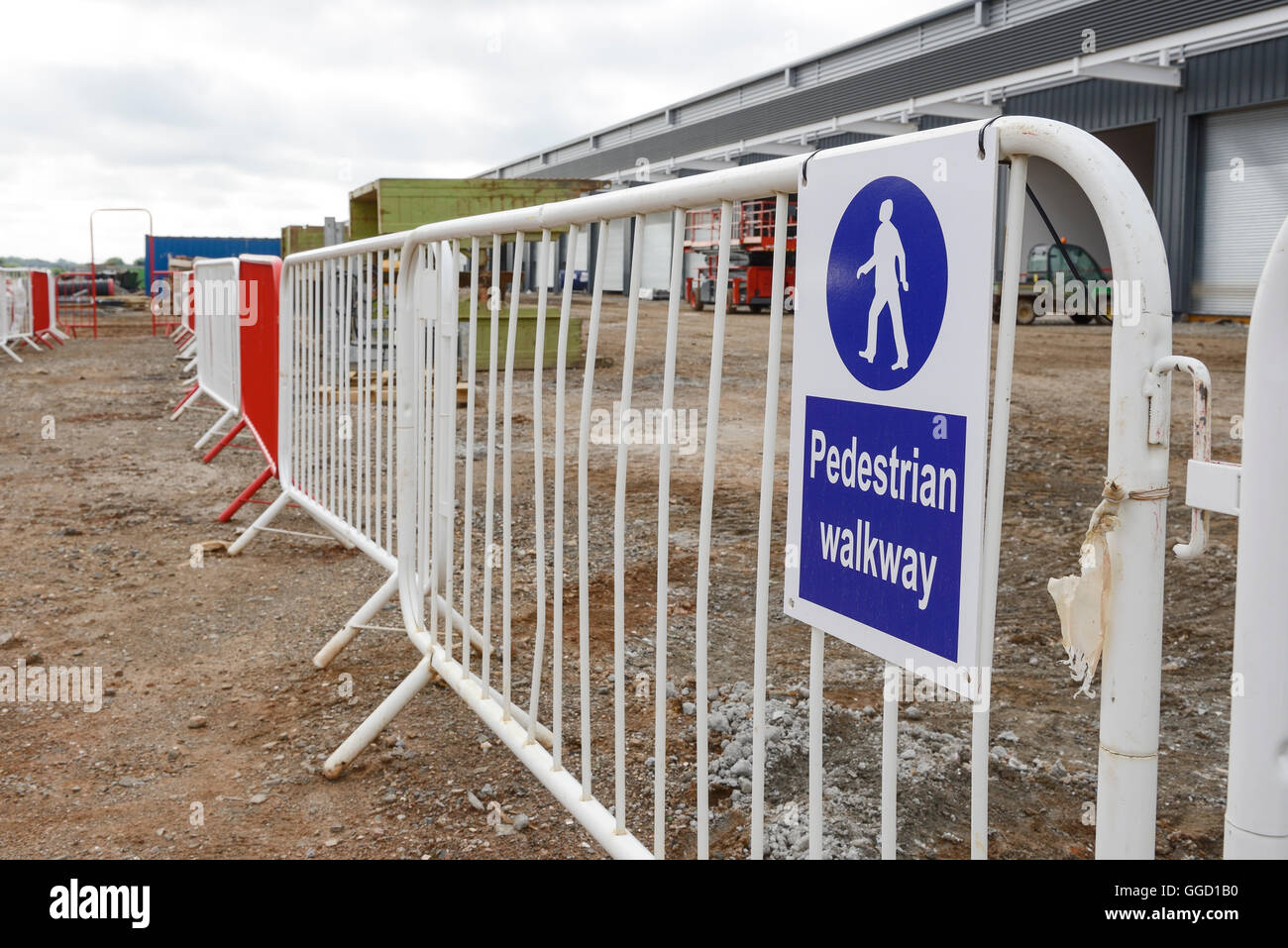 Pedestrian walkway sign and barriers on a UK construction site Stock Photo