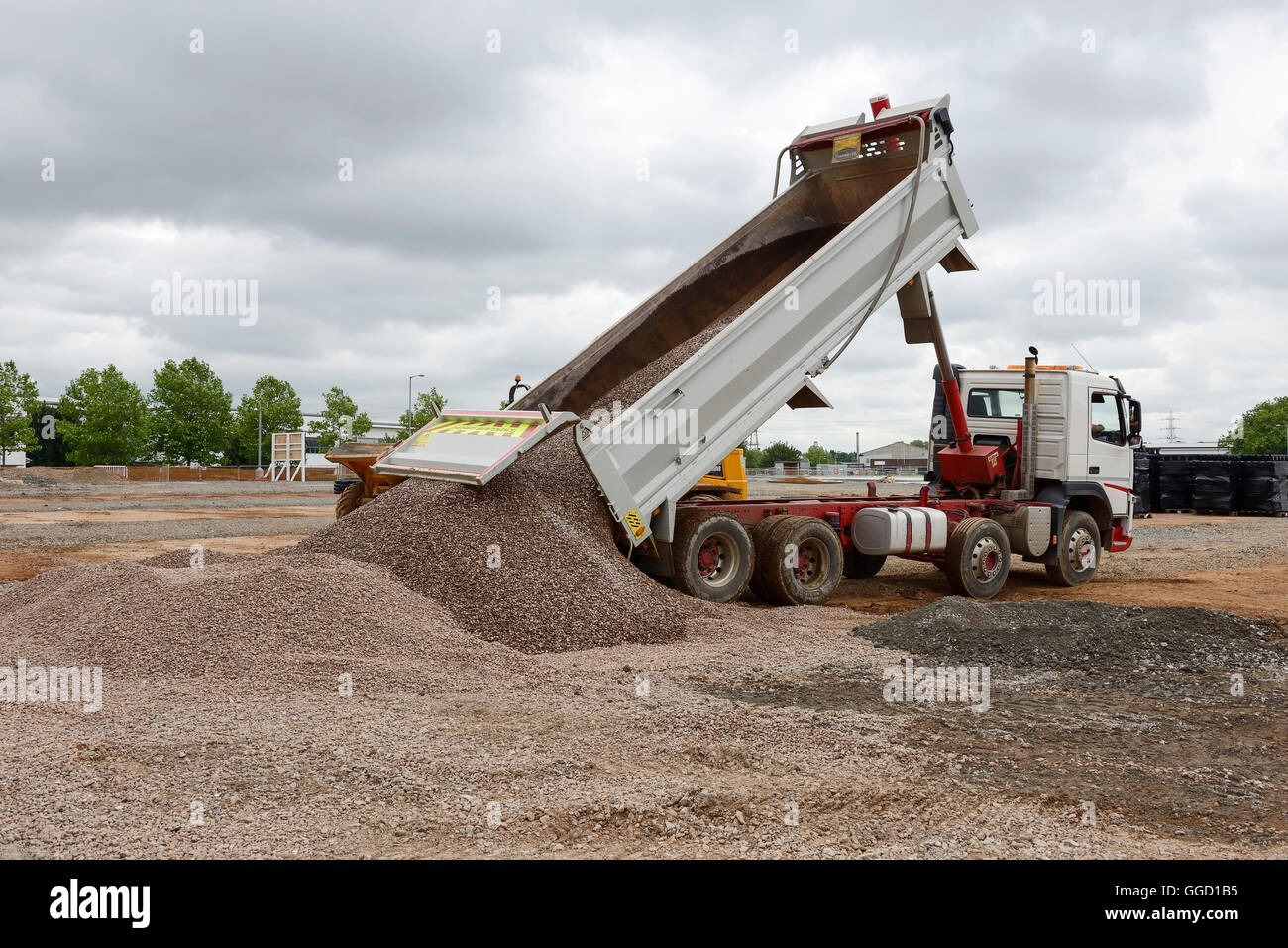 Tipper truck delivering stones at a UK construction site Stock Photo