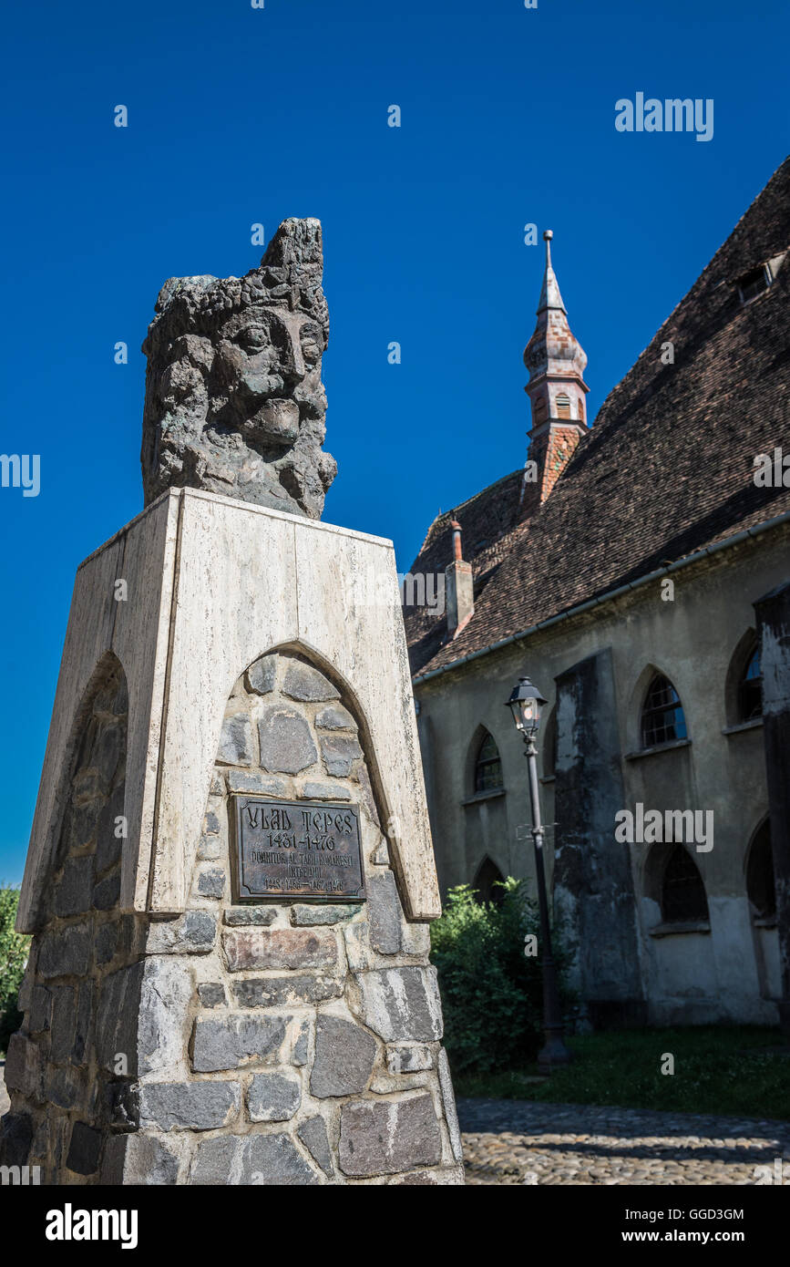 Vlad the Impaler (Vlad Dracula) bust in front of Church of the Dominican Monastery in Historic Centre of Sighisoara, Romania Stock Photo