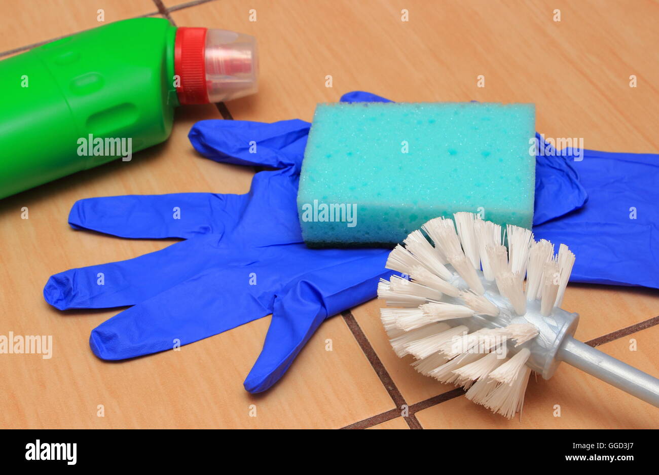 Accessories for cleaning bathroom on ceramics flooring, brush, glove, sponge, concept for house