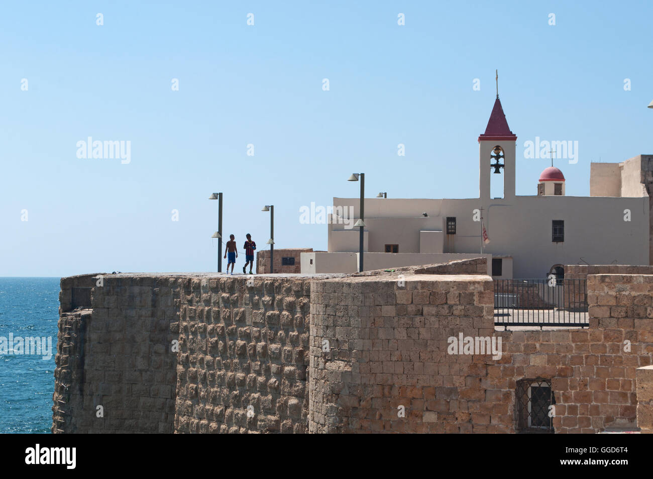 Israel: the Acre Sea Walls, original walls built by Zahir al Umar, the Arab ruler of northern Palestine in 18th century, and the Church of St. John Stock Photo