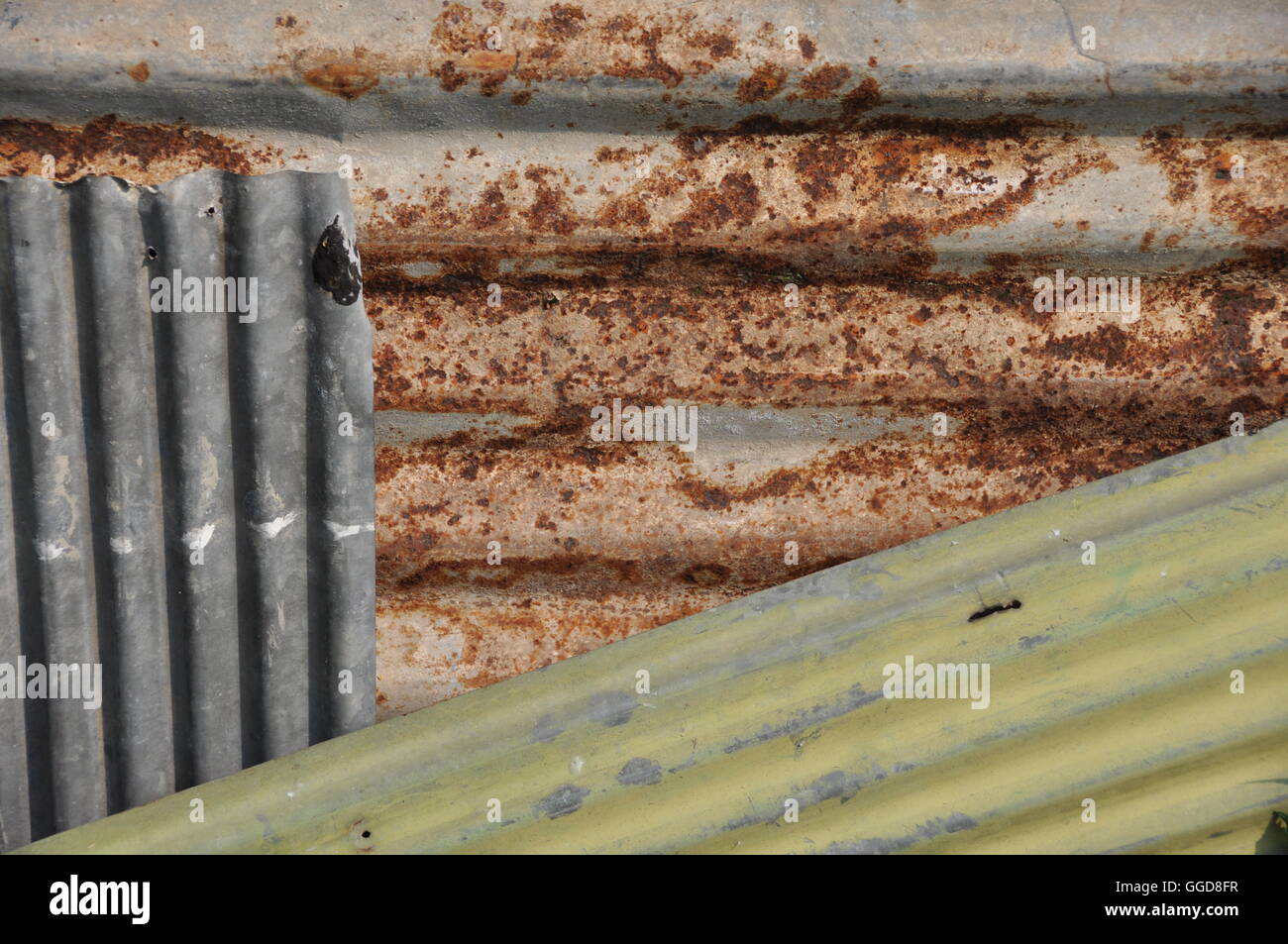 Three different types and colors of sheet metal displaying random