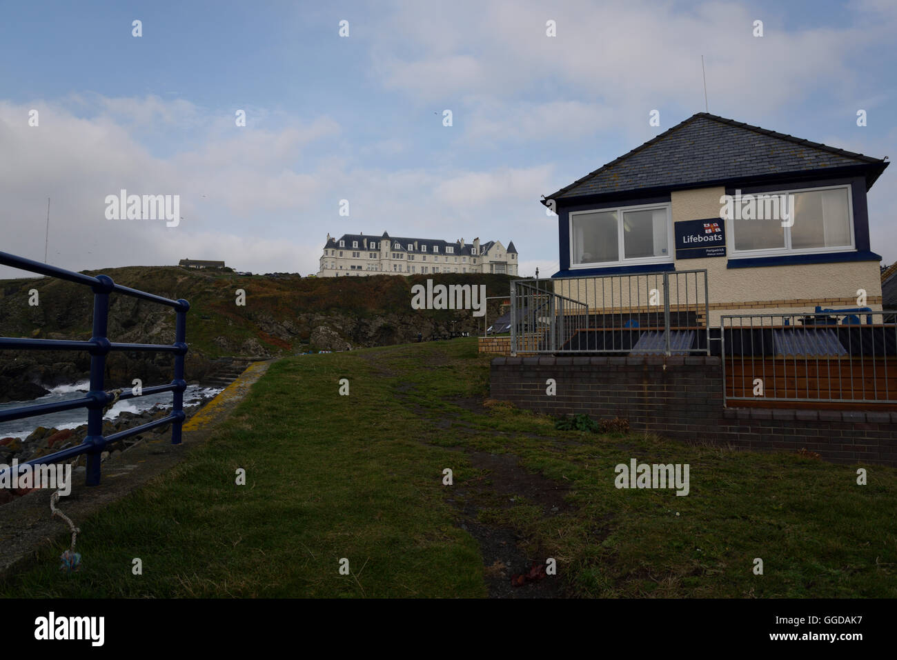 A view with Portpatrick old dock area and cliff top hotel Stock Photo