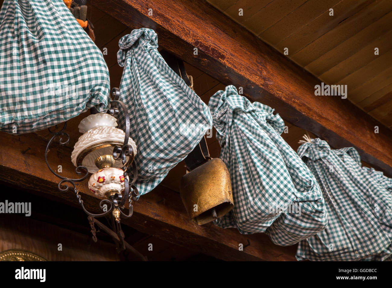 Hams wrapped in cloth for further aging and stored by hanging from the ceiling in farmhouse Stock Photo