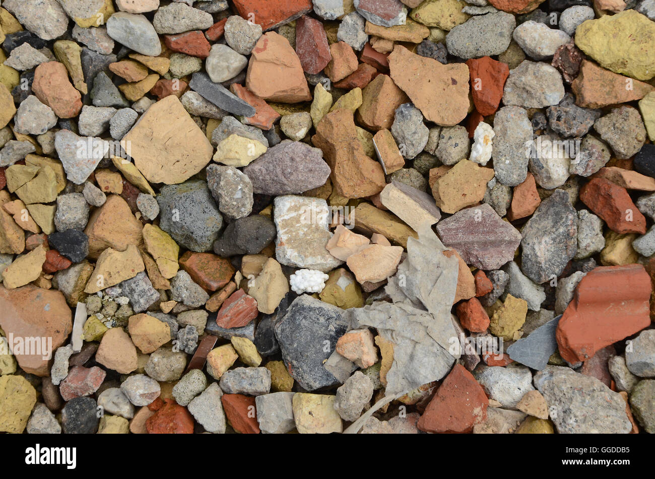 Broken tiles from torn down building serves as temporary road pavement. Stock Photo