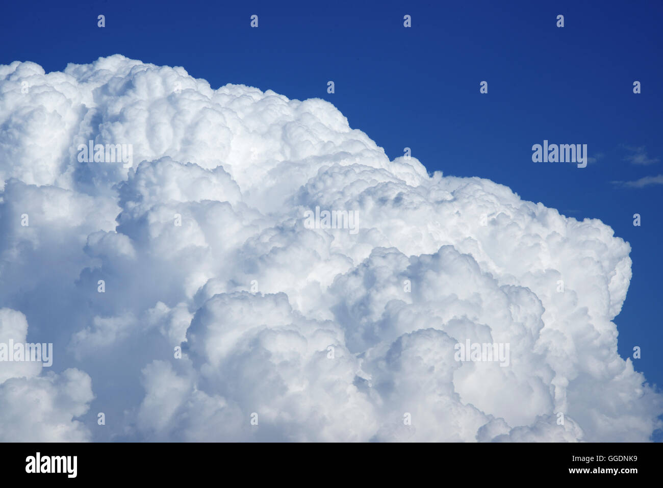 Aerial view of puffy cumulus clouds and deep blue sky taken from high ...