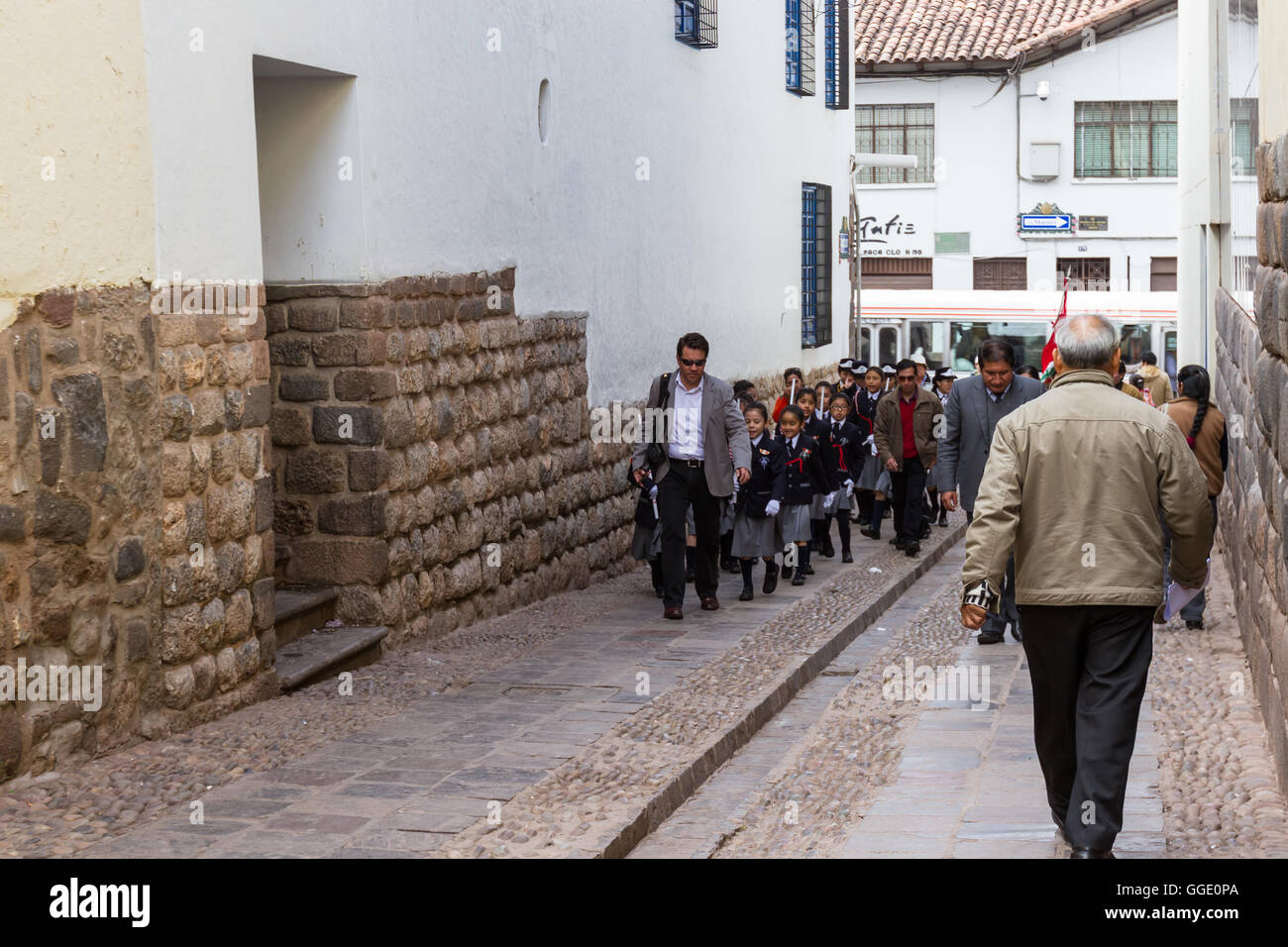 Cusco, Peru - May 12 : Children walking in a row thru alleyways to get to the Plaza de Armas for a Policia Escolar activity. May Stock Photo
