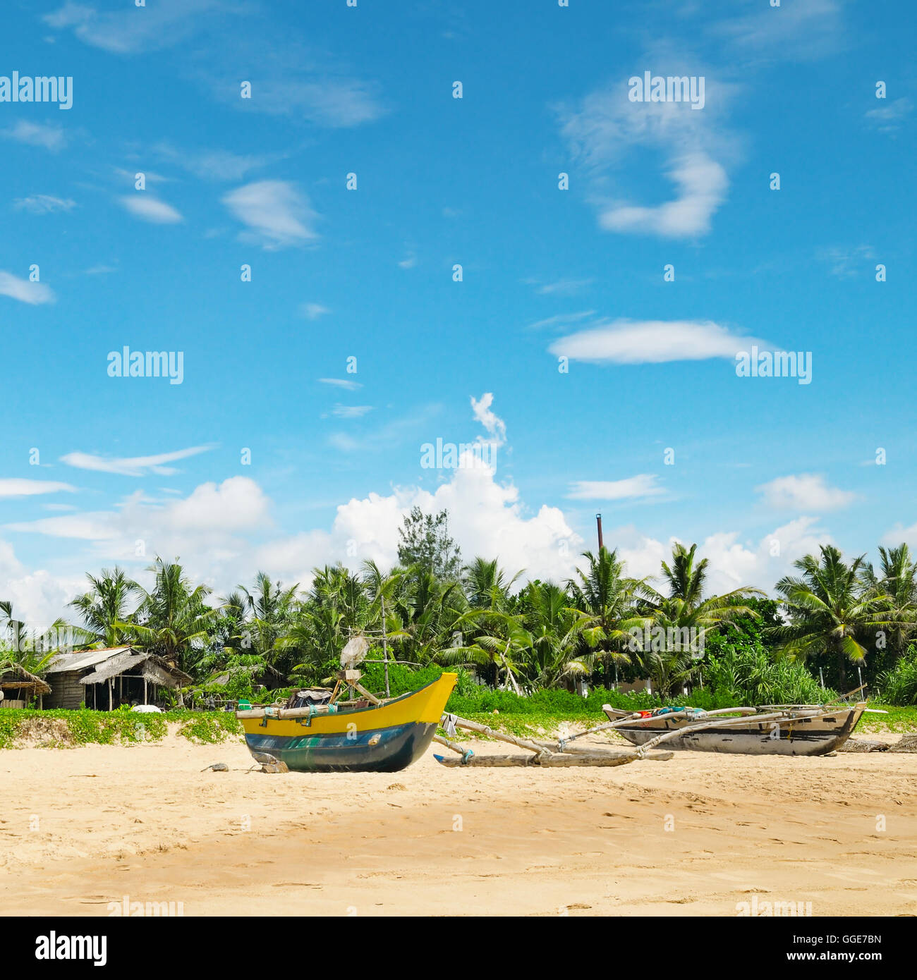 Fishing boats on a tropical beach Stock Photo - Alamy