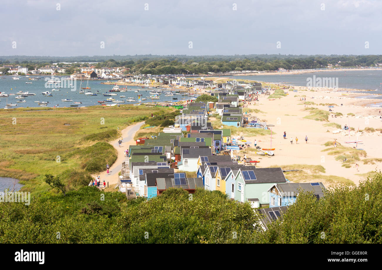 Hengistbury Head, a spit on the coast of Dorset, England, is home to some very desirable beach property - colourful beach huts . Stock Photo