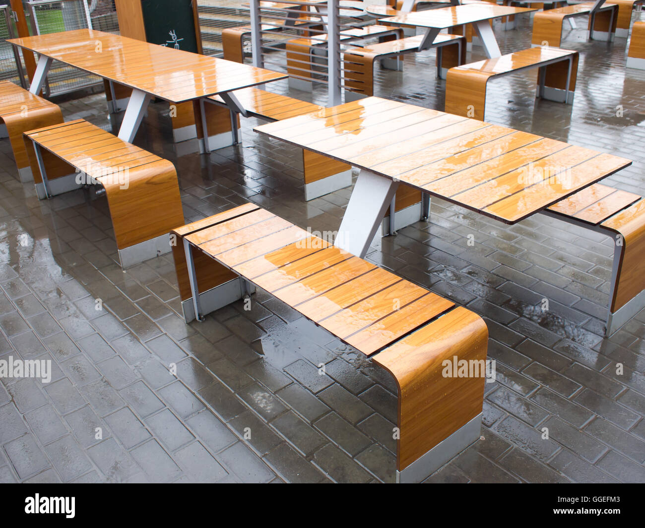 Wet tables outdoor cafe on the street in the rain Stock Photo Alamy