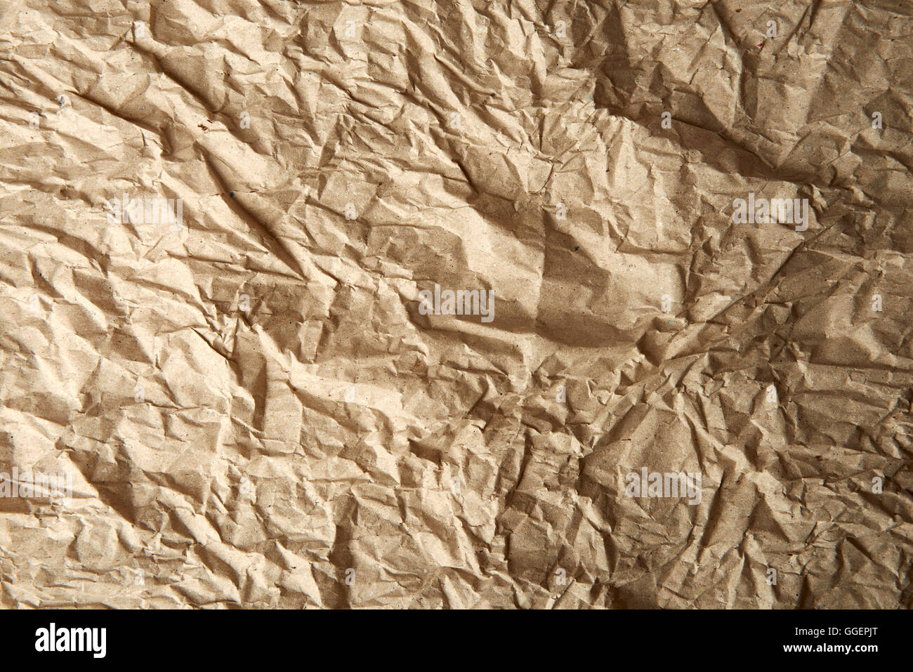 Brown color crumpled paper as a background Stock Photo - Alamy