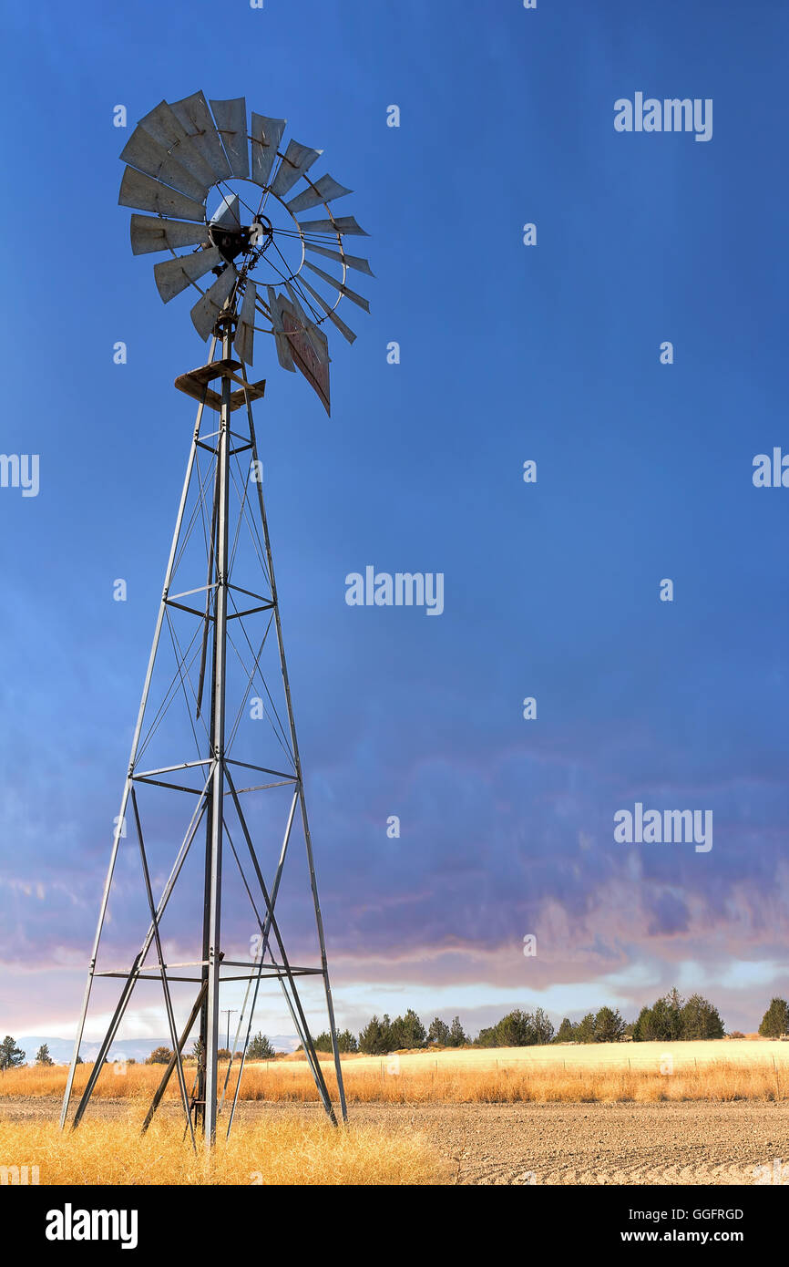 Windmill for Water Pump Well at Wheat Field in Central Oregon Stock Photo