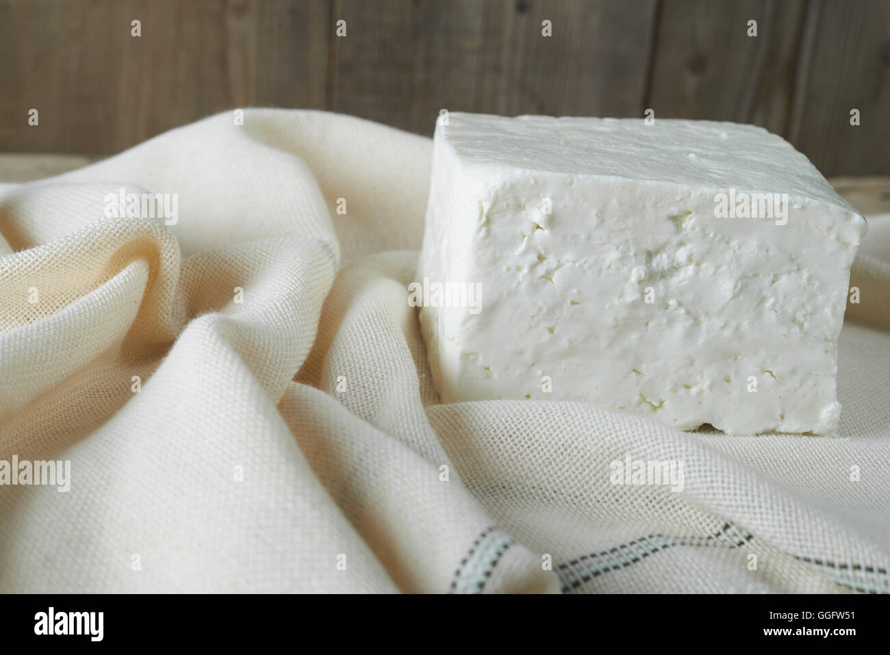 cube of fresh feta cheese on a cheesecloth Stock Photo Alamy