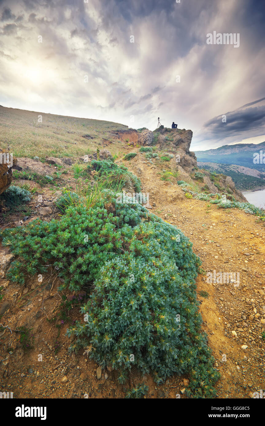 Traveler in the mountains. Photographer in the mountains Stock Photo