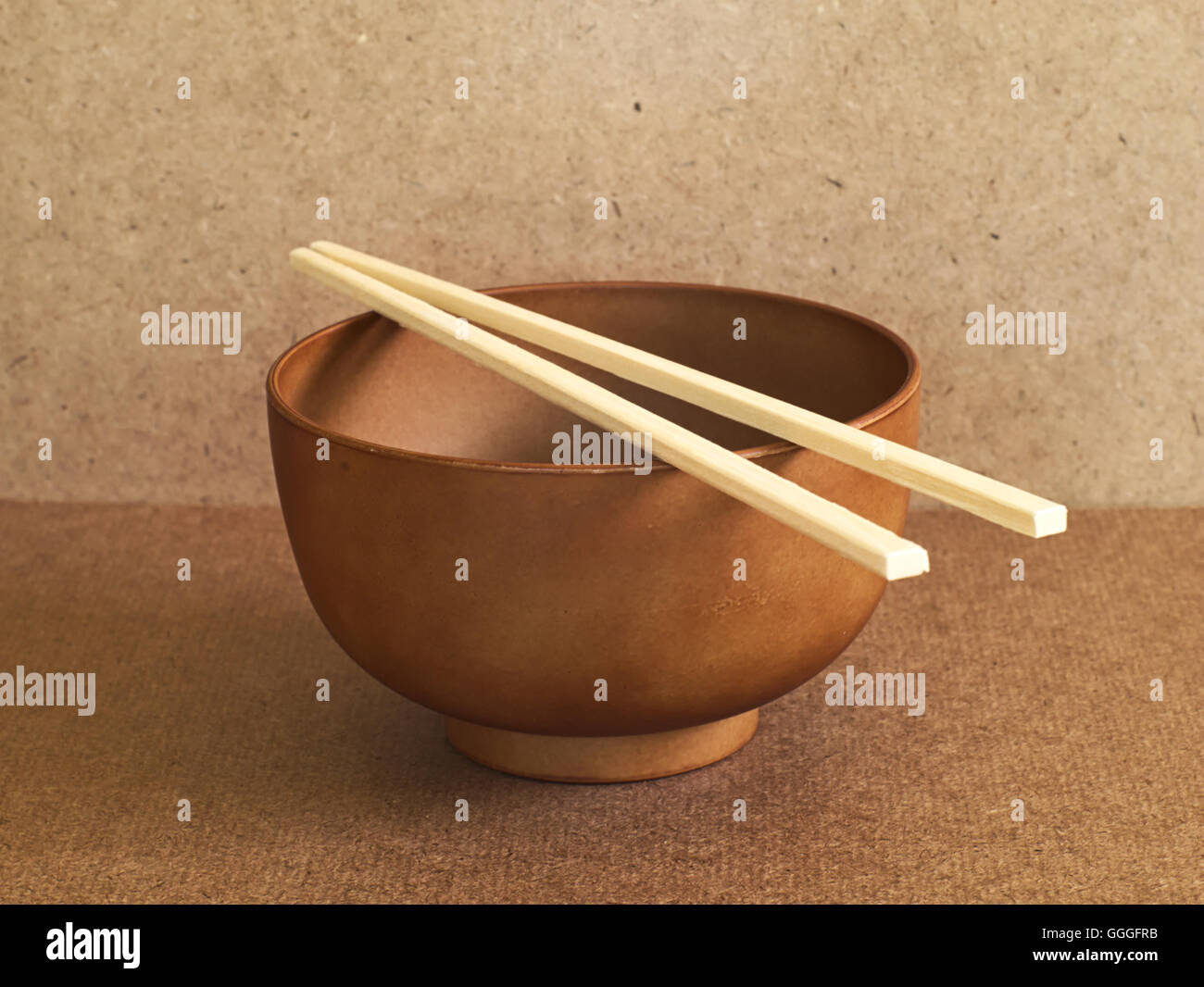 Wooden soup bowl with bamboo chopsticks on wooden table Stock Photo