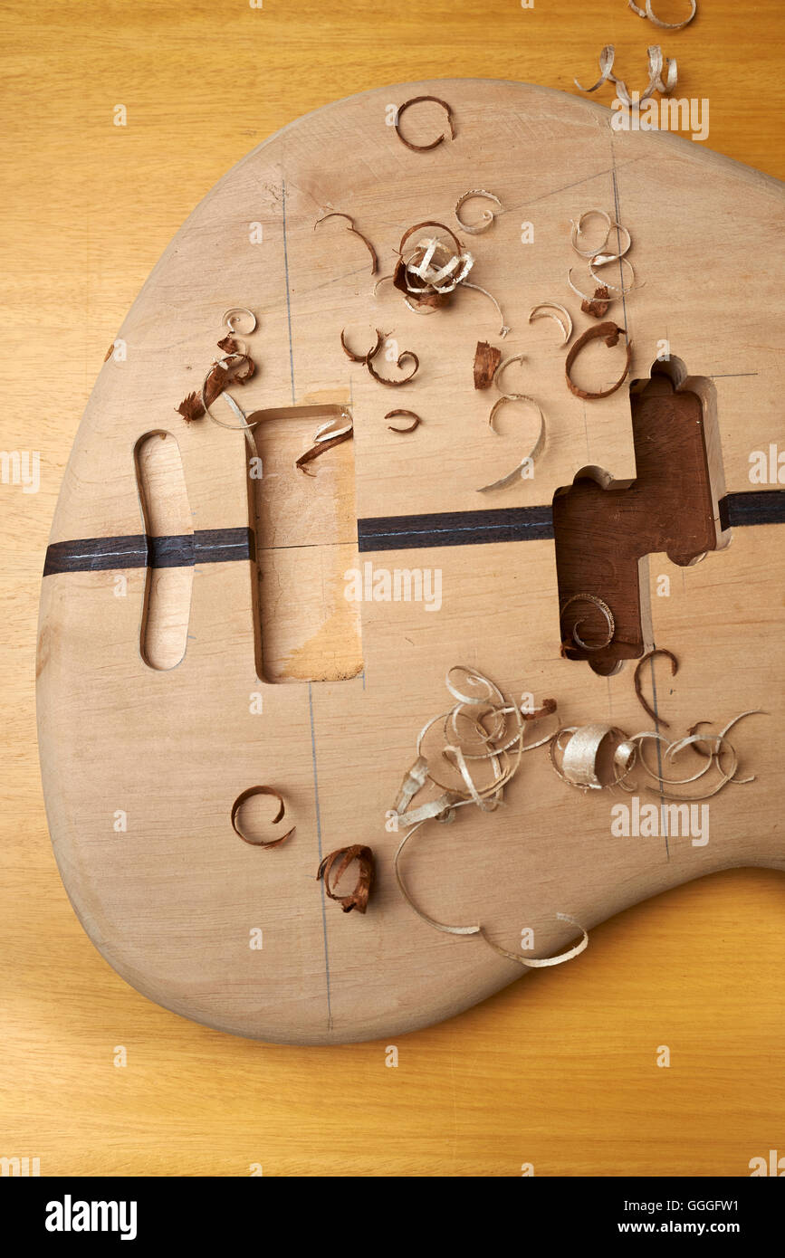 Bass guitar under construction, with tools and accessories Stock Photo