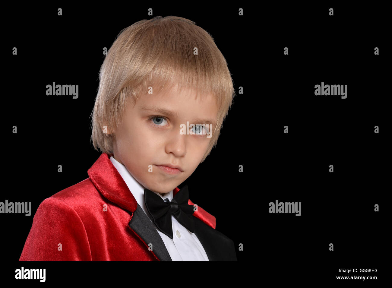 serious little boy in a tuxedo Stock Photo Alamy