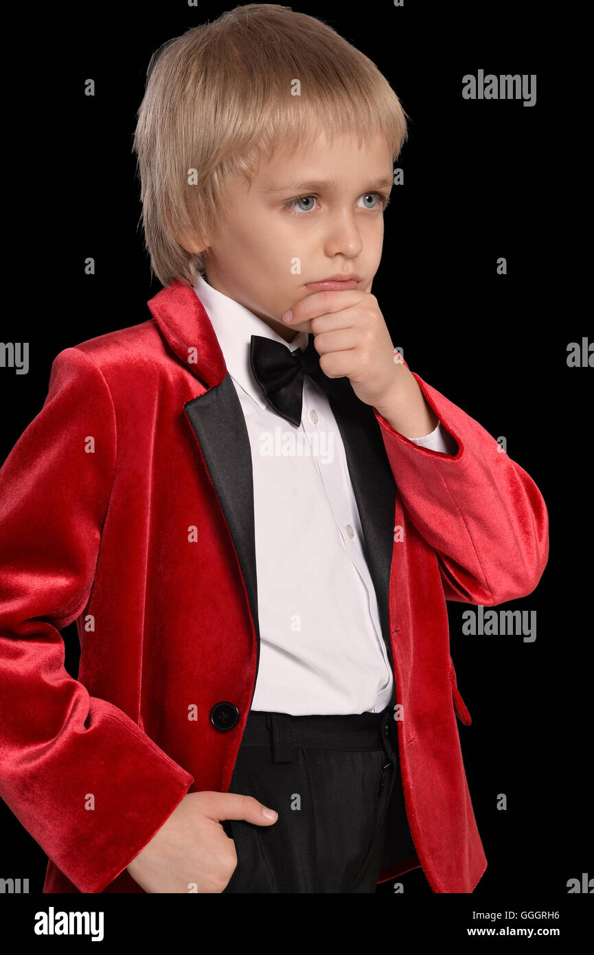 serious little boy in a tuxedo Stock Photo Alamy