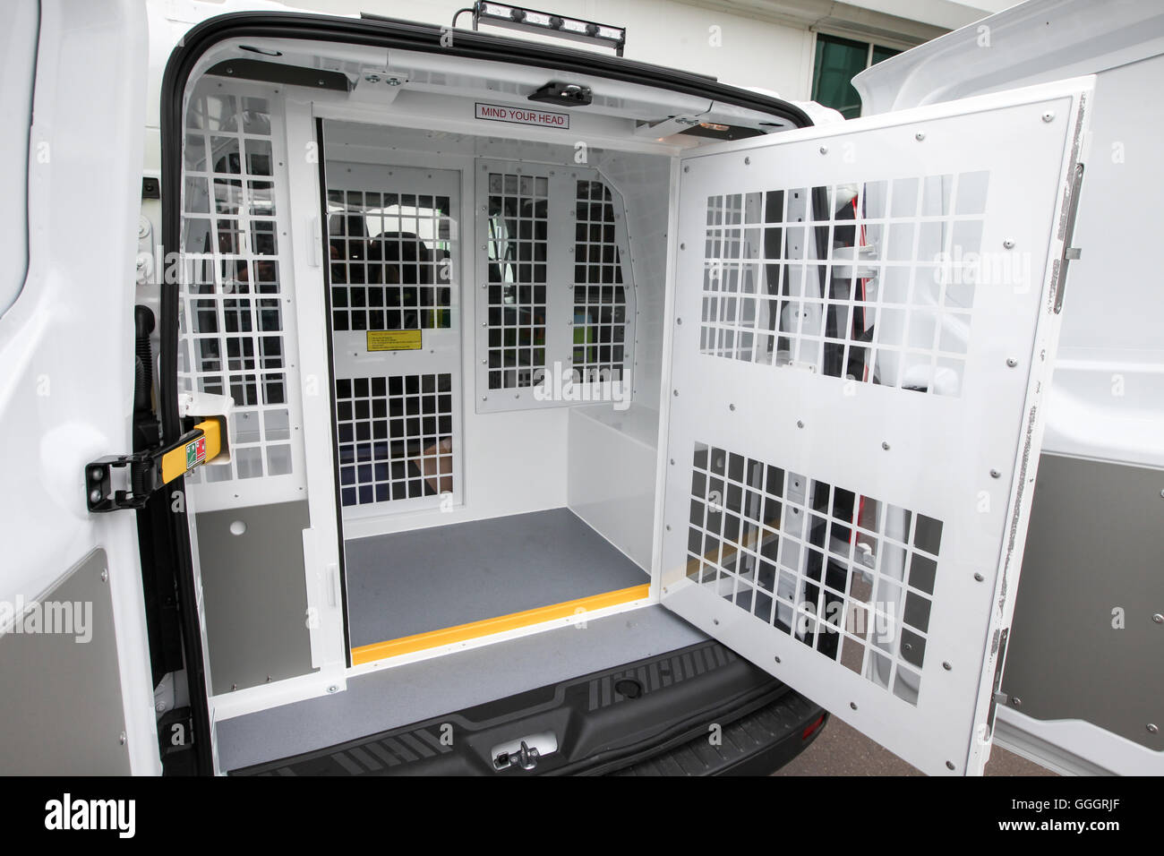 The back of a police van showing the cell where those arrested are detained Stock Photo