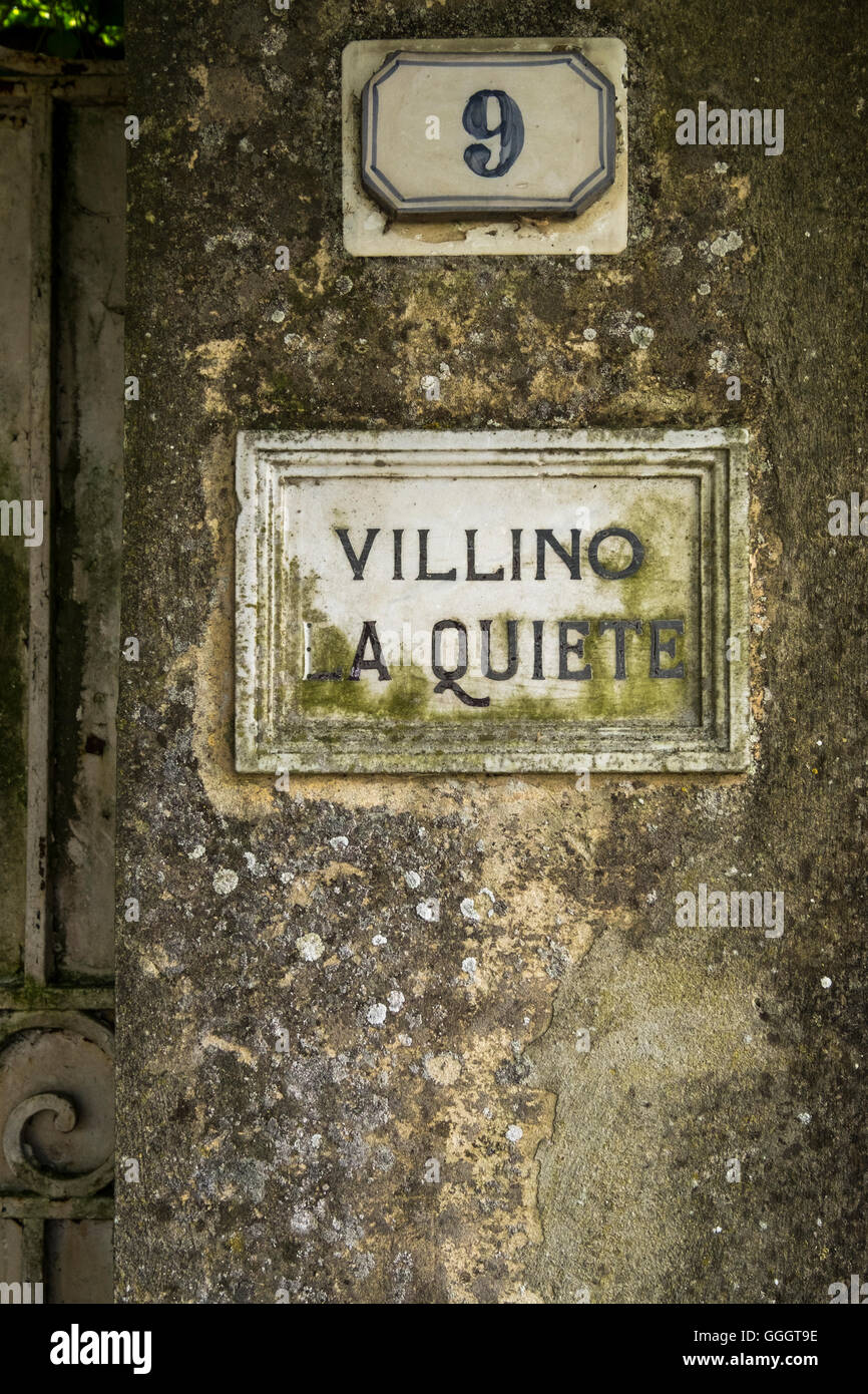 Number nine tile and leaded name on stone gatepost of a villa in Tuscany, Italy Stock Photo